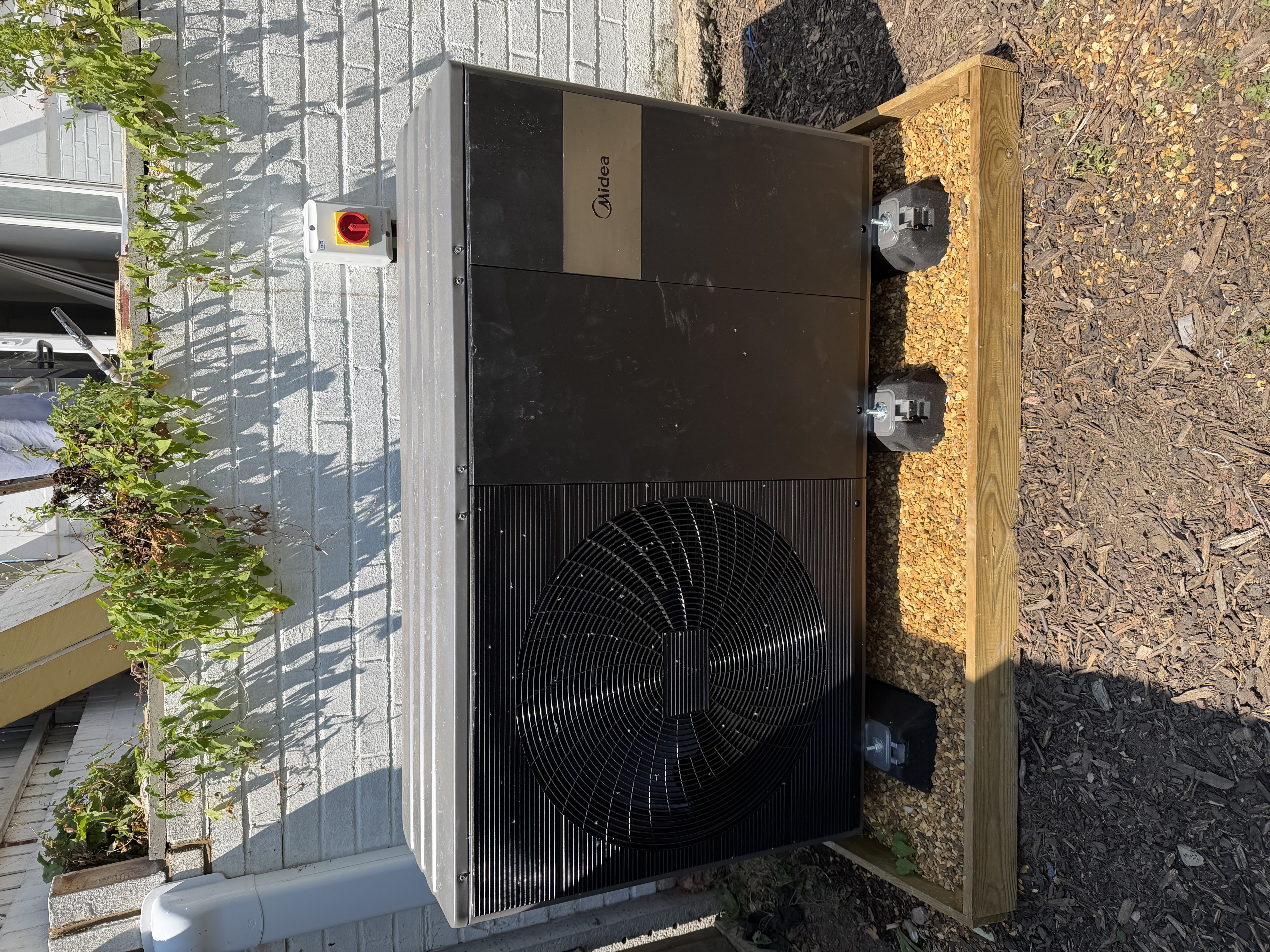 Midea M-Thermal air source heat pump installed on anti-vibration mounts, Hampshire