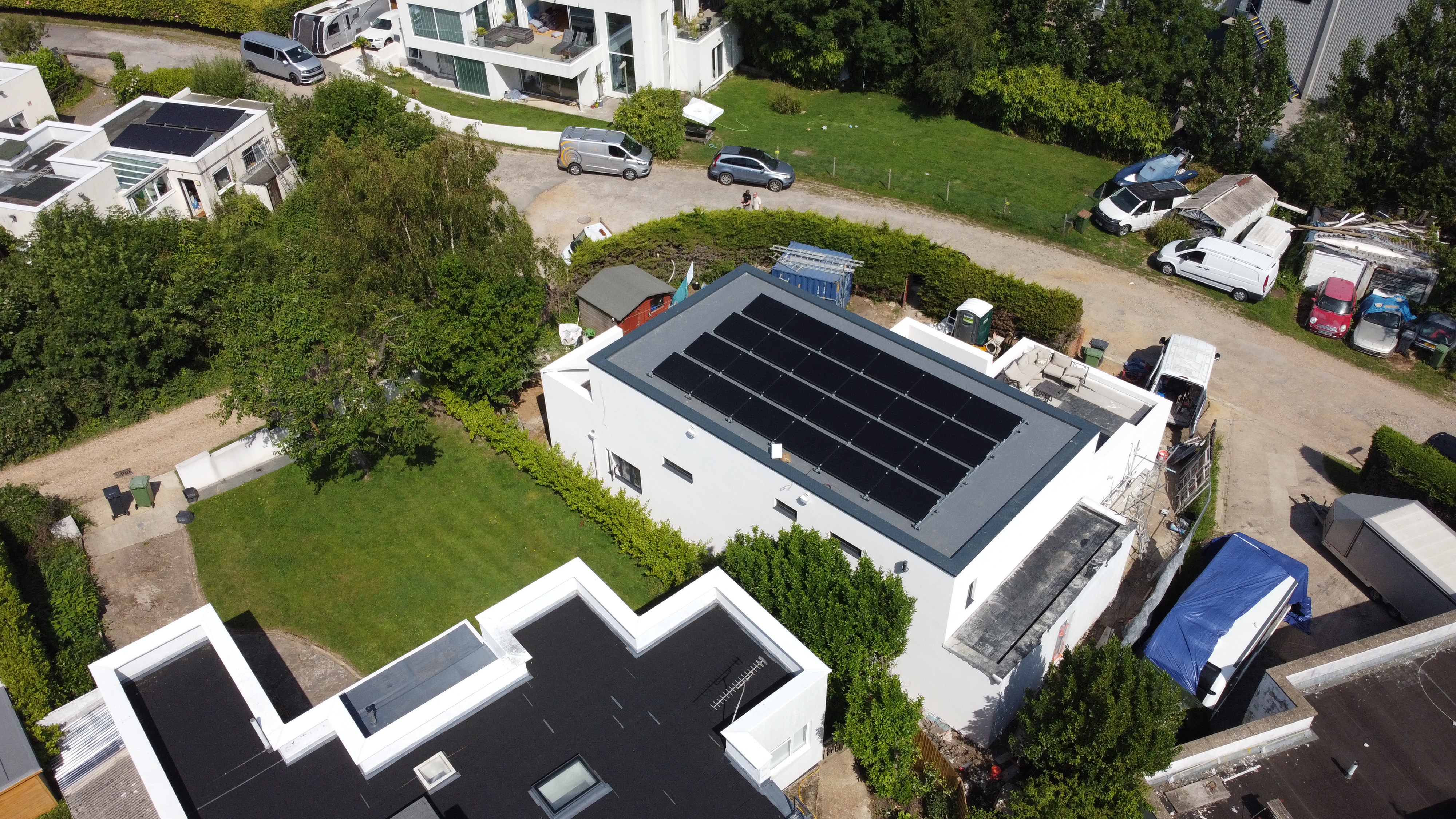 Aerial view of solar panels on large luxury property with swimming pool