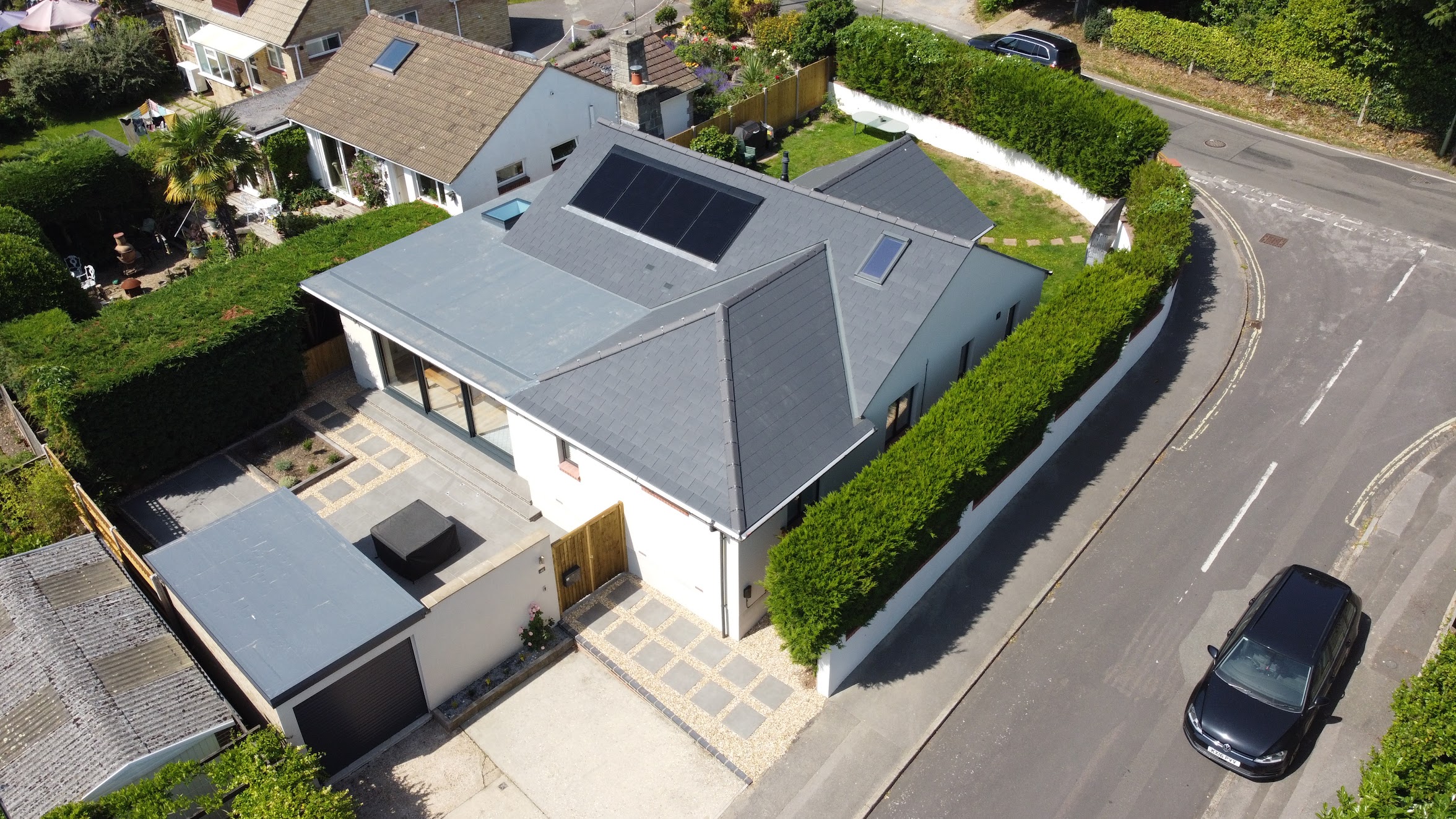 Drone shot of solar panels on contemporary slate-roof home