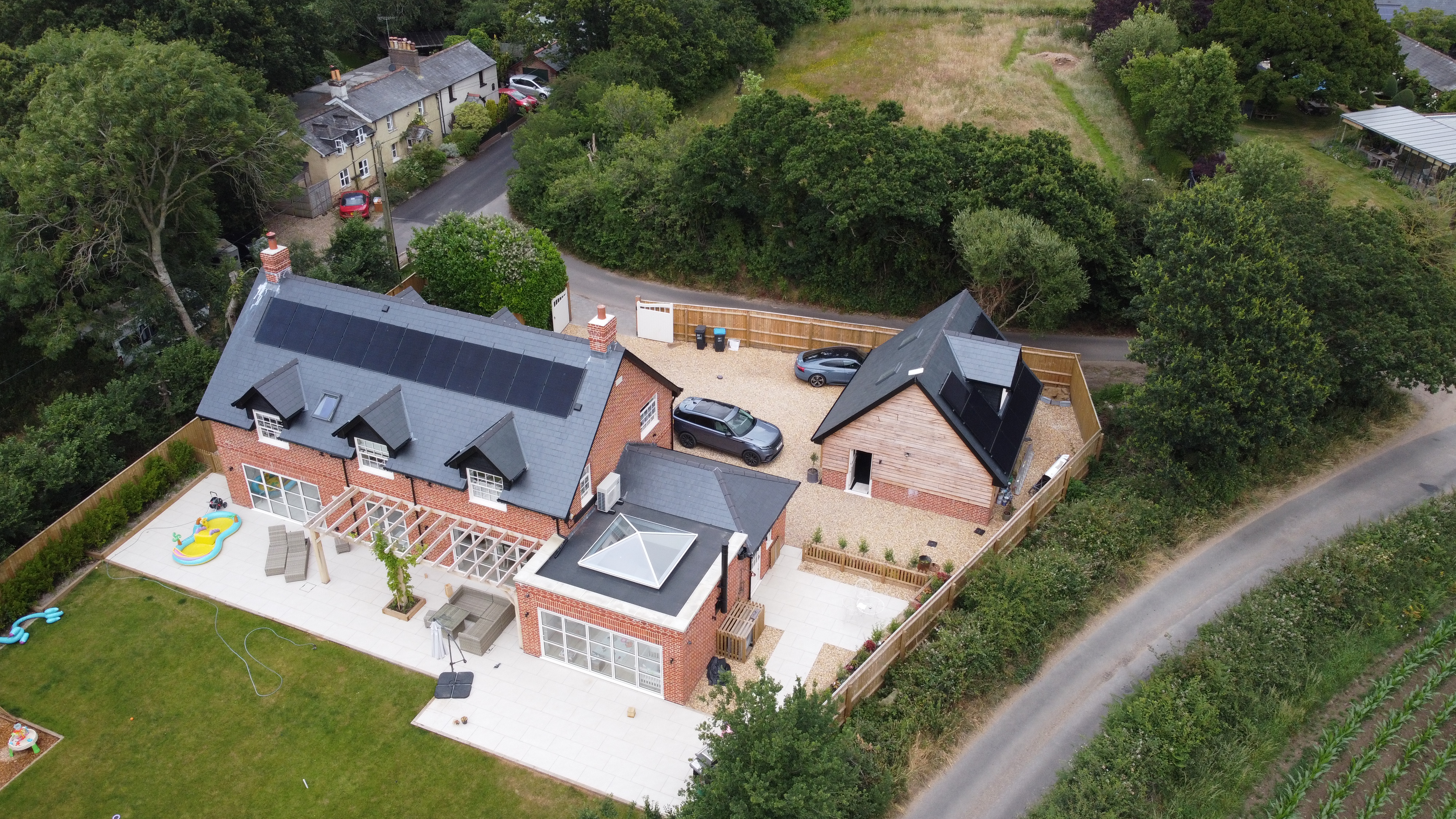 Aerial view of solar panels across multiple roof sections, Hampshire